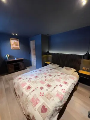 a bedroom with a bed with a quilt on it at Appartement Lyret centre Chamonix, Vue d'exception in Chamonix-Mont-Blanc