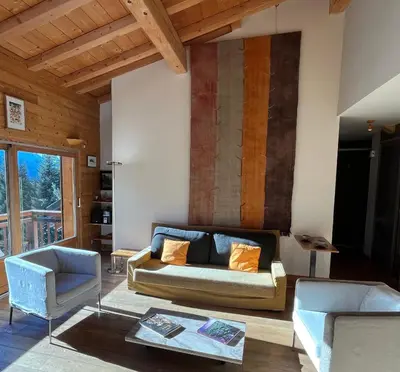 a living room with a couch and a chair at Appartement Arolles in Chamonix-Mont-Blanc