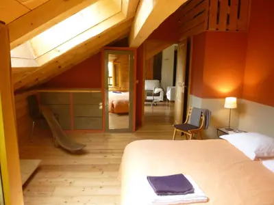 a bedroom with a large bed and a room with a bedroom at Appartement Arolles in Chamonix-Mont-Blanc