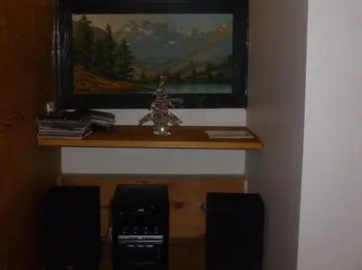 a shelf in a room with a picture of a mountain at Appartement Arolles in Chamonix-Mont-Blanc
