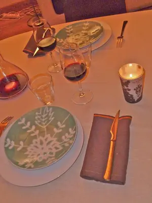 a table topped with plates and glasses of wine at Appartement Arolles in Chamonix-Mont-Blanc