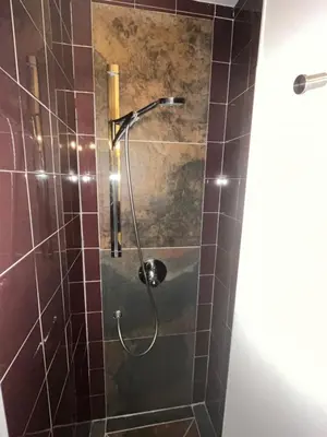 a shower with a shower head in a bathroom at Appartement Arolles in Chamonix-Mont-Blanc
