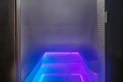 a hot tub with purple and blue lights in a bathroom at La Cordee 124 Apartment - Chamonix All Year in Chamonix-Mont-Blanc