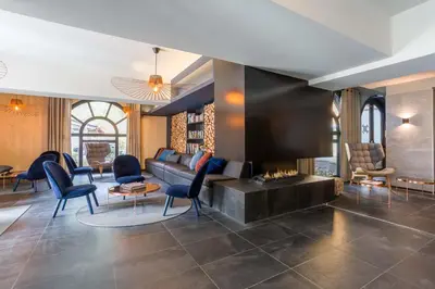 a living room with a couch and a fireplace at La Cordee 124 Apartment - Chamonix All Year in Chamonix-Mont-Blanc