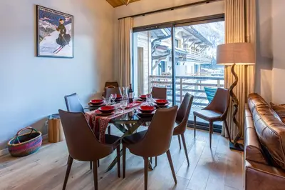 a dining room with a table and chairs and a window at La Cordee 124 Apartment - Chamonix All Year in Chamonix-Mont-Blanc