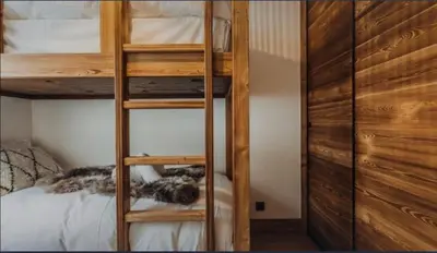 a ladder to a bunk bed in a bedroom at Interlude Megeve in Megève