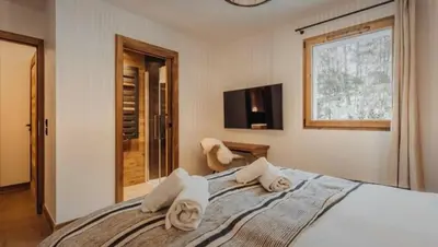 a bedroom with a bed with towels on it at Interlude Megeve in Megève