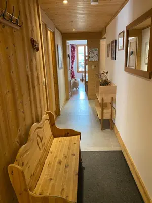 a hallway with a wooden bench in a room at Appartement Le Lutetia in Chamonix-Mont-Blanc
