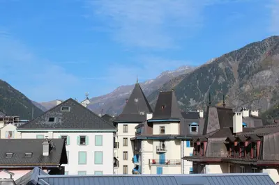 a group of buildings with mountains in the background at Appartement Le Lutetia in Chamonix-Mont-Blanc