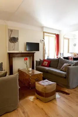 a living room with a couch and a table at Appartement Le Lutetia in Chamonix-Mont-Blanc