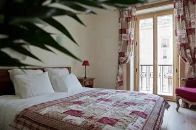 a bedroom with a bed with a quilt on it at Appartement Le Lutetia in Chamonix-Mont-Blanc