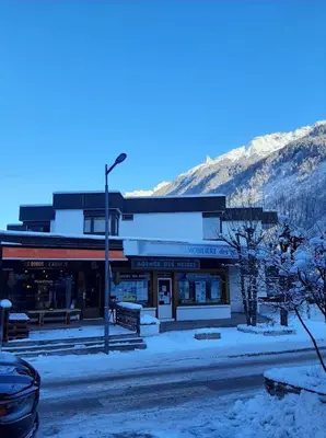 a building on a street with snow on the ground at Chamonix centre - WIFI - Parking - Rés Aiguille du midi in Chamonix-Mont-Blanc