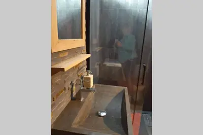 a bathroom with a shower with a sink and a mirror at Chamonix centre - WIFI - Parking - Rés Aiguille du midi in Chamonix-Mont-Blanc