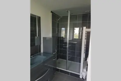 a bathroom with a shower and a tub at maisonnette entre lac de Passy et montagnes in Domancy