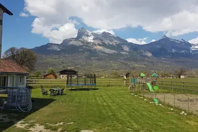 a playground with a mountain in the background at maisonnette entre lac de Passy et montagnes in Domancy