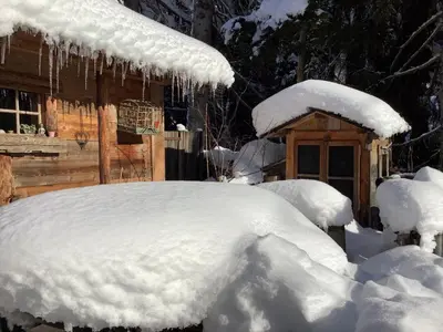 a yard covered in snow next to a cabin at Charmant Mazot in Saint-Gervais-les-Bains