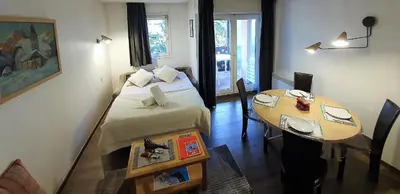 a small room with a bed and a table at La Rivière Vue Mont Blanc in Chamonix-Mont-Blanc