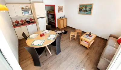 a room with a table and a dog in a kitchen at La Rivière Vue Mont Blanc in Chamonix-Mont-Blanc