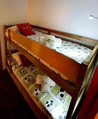 a wooden bunk bed with cows on it at La Rivière Vue Mont Blanc in Chamonix-Mont-Blanc