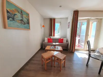 a living room with a table and a couch at La Rivière Vue Mont Blanc in Chamonix-Mont-Blanc