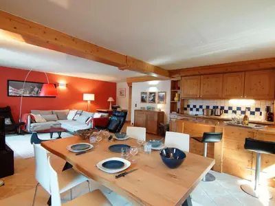 a kitchen and living room with a wooden table at Apartment Villa Princesse by Interhome in Chamonix-Mont-Blanc