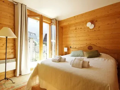 a bedroom with a bed in a room with wooden walls at Apartment Villa Princesse by Interhome in Chamonix-Mont-Blanc