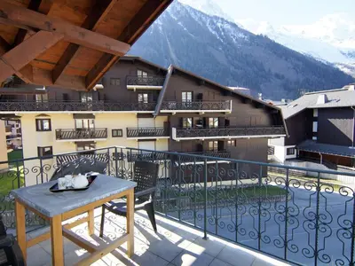 a balcony with a table and a view of a building at Apartment Villa Princesse by Interhome in Chamonix-Mont-Blanc