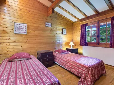 two beds in a room with wooden walls at Chalet plein soleil 2 chambres à Megève, proche pistes - FR-1-453-255 in Megève