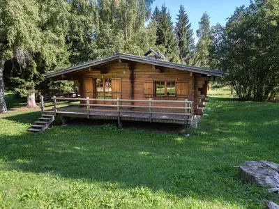 a log cabin in a field of green grass at Chalet plein soleil 2 chambres à Megève, proche pistes - FR-1-453-255 in Megève