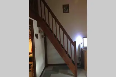 a hallway with a wooden staircase in a house at Studio « Au beau soleil » in Saint-Gervais-les-Bains