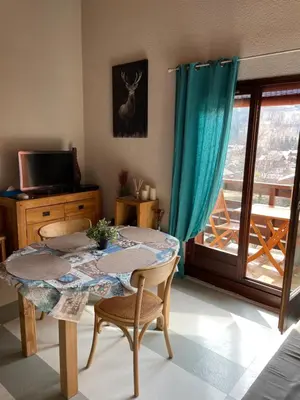 a room with a table and chairs and a window at Studio « Au beau soleil » in Saint-Gervais-les-Bains