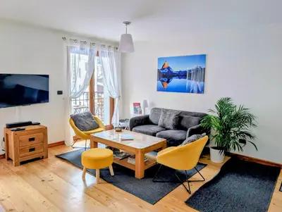 a living room with a couch and a table at Cham'Heart, 4-star apartments in Chamonix centre with free private parking in Chamonix-Mont-Blanc