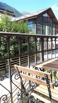 a wooden bench sitting on top of a balcony at Cham'Heart, 4-star apartments in Chamonix centre with free private parking in Chamonix-Mont-Blanc