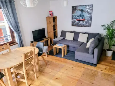 a living room with a couch and a table at Cham'Heart, 4-star apartments in Chamonix centre with free private parking in Chamonix-Mont-Blanc