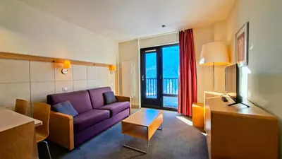 a living room with a purple couch and a table at Residence De La Foret - Appartement lumineux · Proche des pistes · Balcon MAE-5774 in Flaine