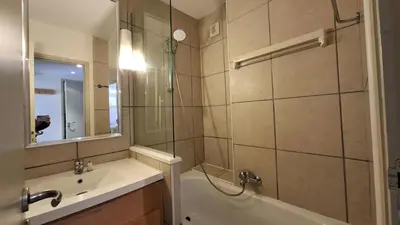a bathroom with a tub and a sink and a shower at Residence De La Foret - Appartement lumineux · Proche des pistes · Balcon MAE-5774 in Flaine