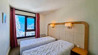 a room with two beds and a large window at Residence De La Foret - Appartement lumineux · Proche des pistes · Balcon MAE-5774 in Flaine