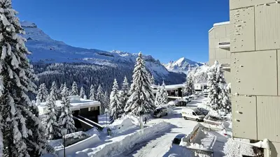 a snow covered mountain with trees and a building at Residence De La Foret - Appartement lumineux · Proche des pistes · Balcon MAE-5774 in Flaine