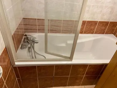 a bathroom with a bath tub with a faucet at Les Frahans in Samoëns