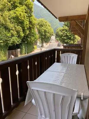 a white table and chairs on a balcony at Les Frahans in Samoëns
