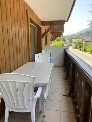 a white table and chairs on a balcony at Les Frahans in Samoëns