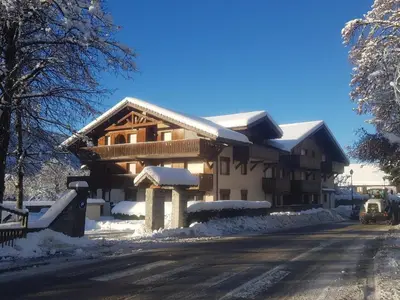 a house covered in snow on the side of a road at Les Frahans in Samoëns