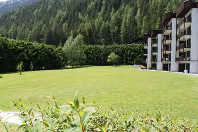 a large green field in front of a building at studio residence Grands Montets in Chamonix-Mont-Blanc