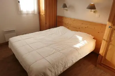 a bedroom with a white bed in a room at Le Grand Panorama in Saint-Gervais-les-Bains