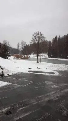 an empty parking lot with snow on the ground at Studio pieds des pistes les Houches Vallée de Chamonix in Les Houches