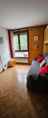 a bedroom with a bed and a large window at Studio pieds des pistes les Houches Vallée de Chamonix in Les Houches