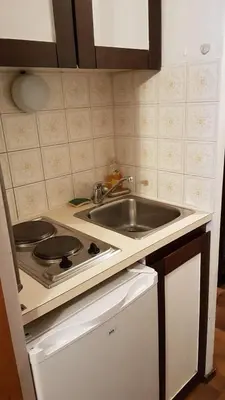 a kitchen with a sink and a stove at Studio pieds des pistes les Houches Vallée de Chamonix in Les Houches