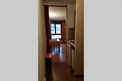 a room with a kitchen and a dining room at Studio pieds des pistes les Houches Vallée de Chamonix in Les Houches