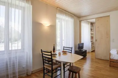 a dining room with a wooden table and chairs at Appartement du Mont - Résidence La Vardaffe - Welkeys in Chamonix-Mont-Blanc