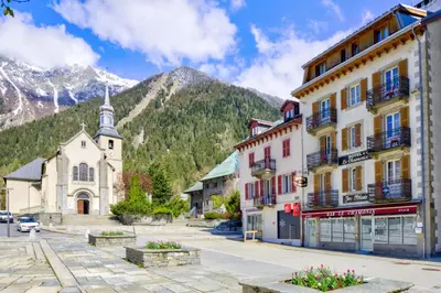 a street in a town with a church and a mountain at Appartement du Mont - Résidence La Vardaffe - Welkeys in Chamonix-Mont-Blanc